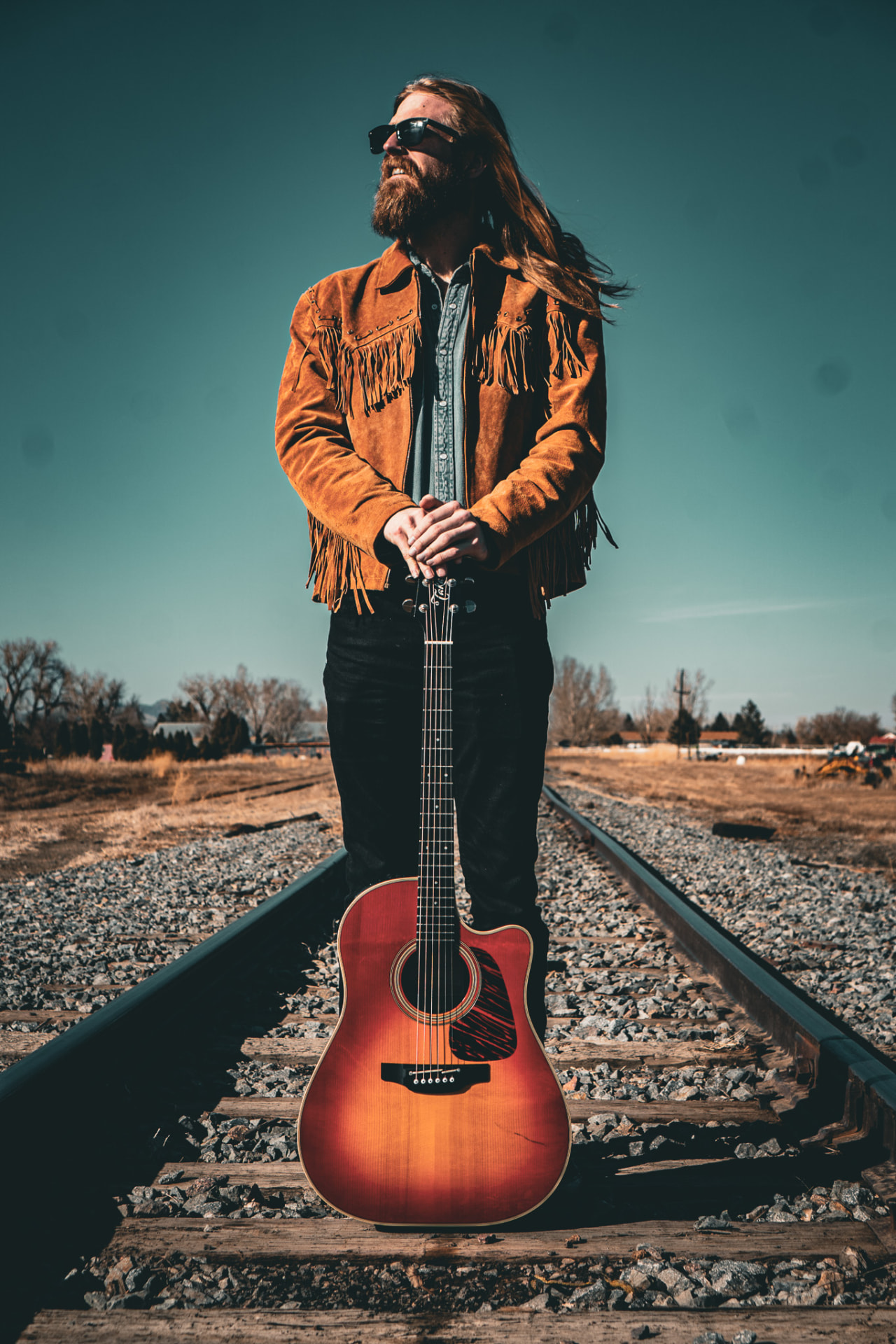 Fringe jacket portrait on the railroad tracks