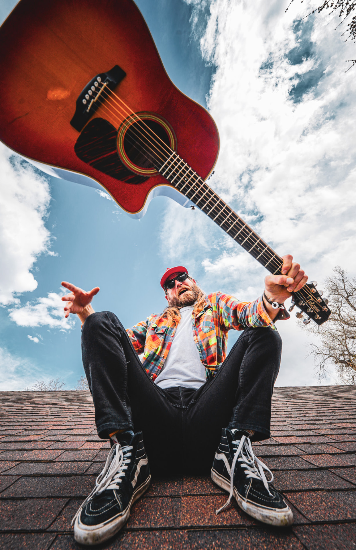Rooftop portrait, guitar tossed overhead
