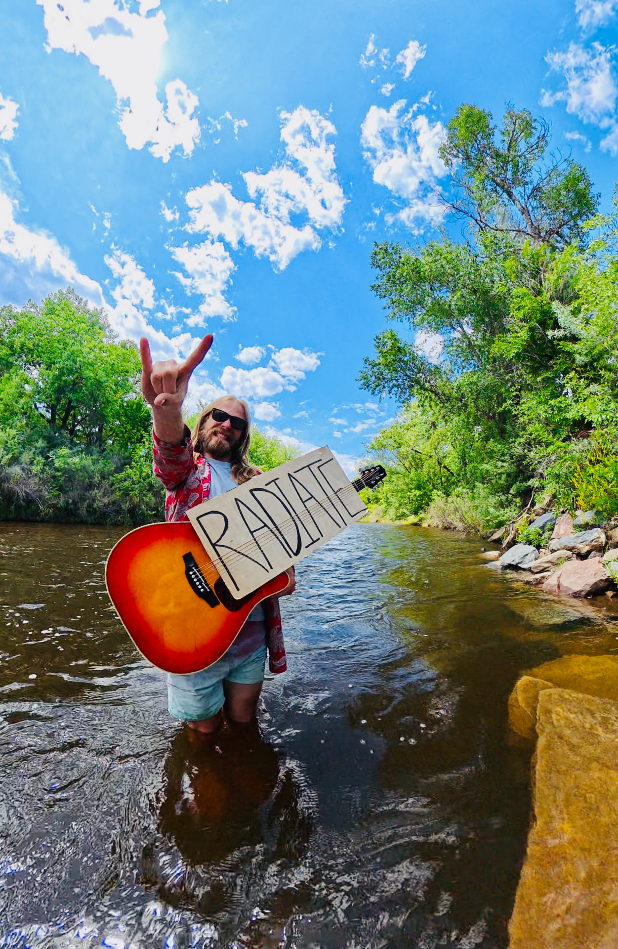 RADIATE sign held in the river